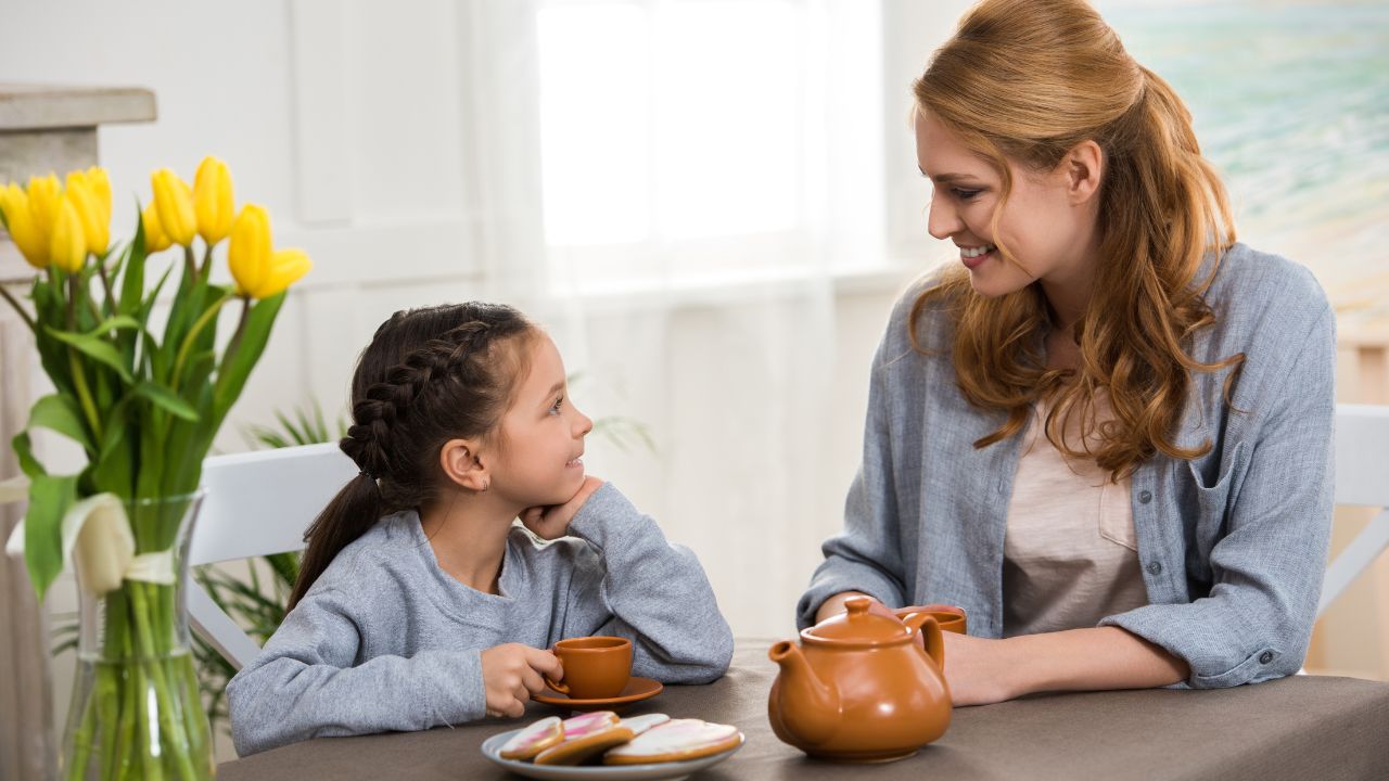 woman and daughter drinking tea together