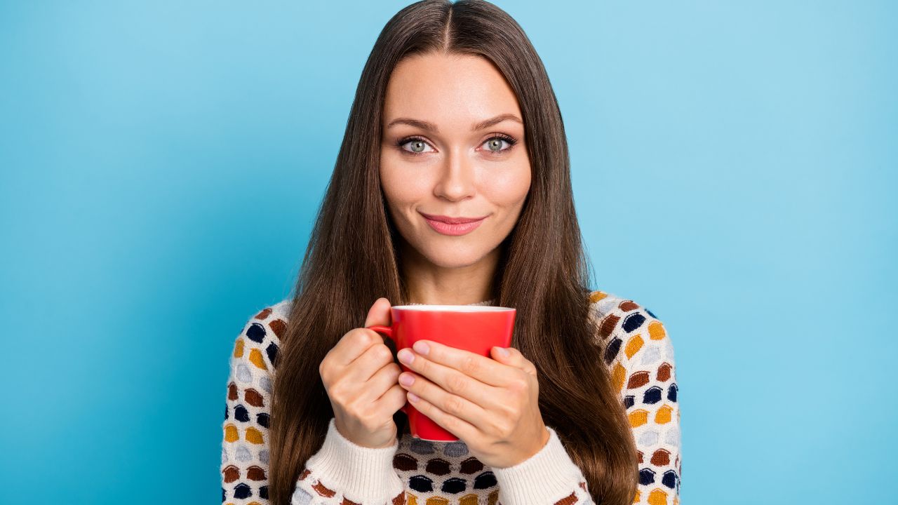 woman drinking tea from mug