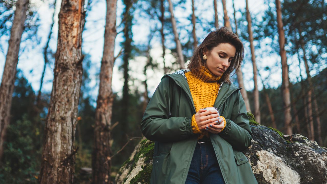 woman holding coffee and hiking