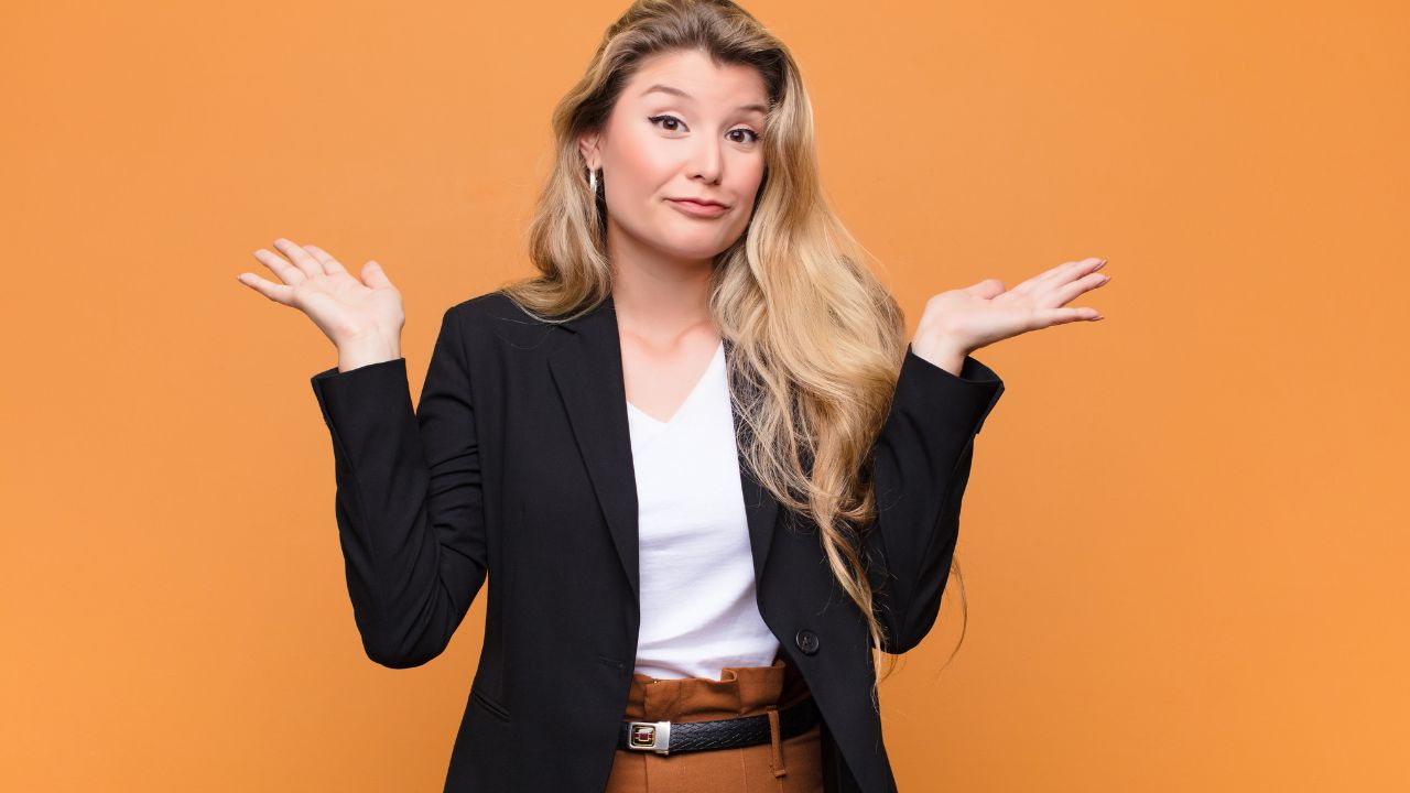 woman professional looking confused with hands up