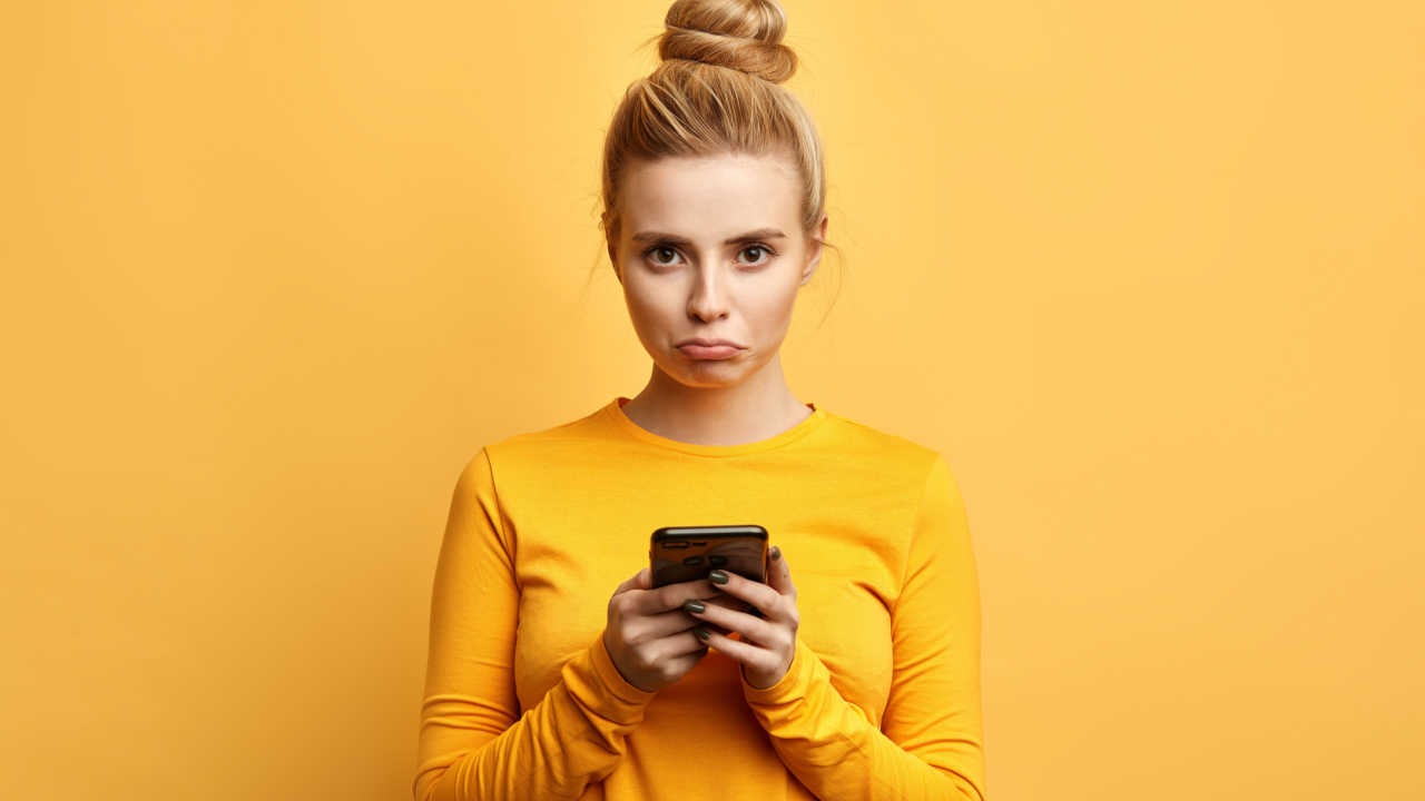 woman on cell phone looking sad