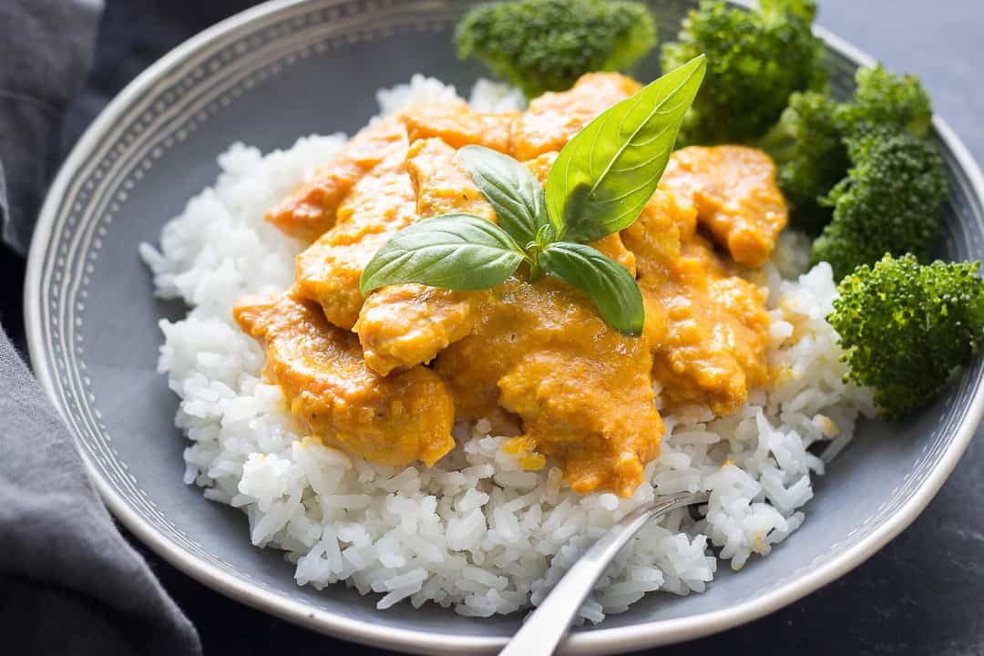 pumpkin chicken curry in a plate on a bed of rice