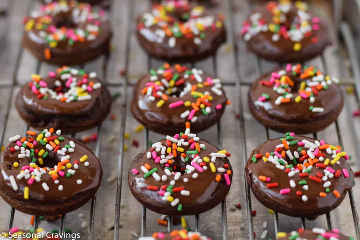 chocolate donuts with sprinkles on top on a tray