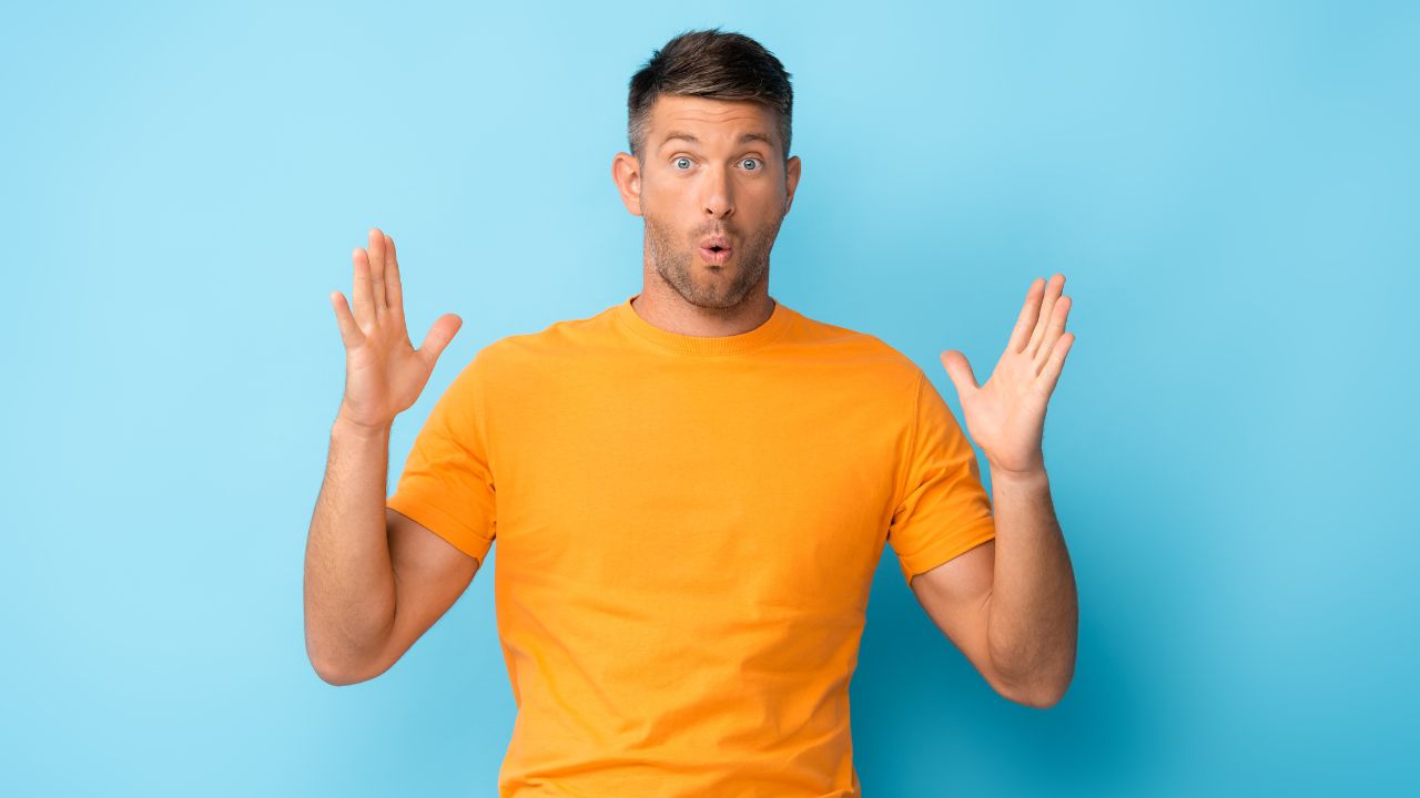 man looking surprised and confused with hands out