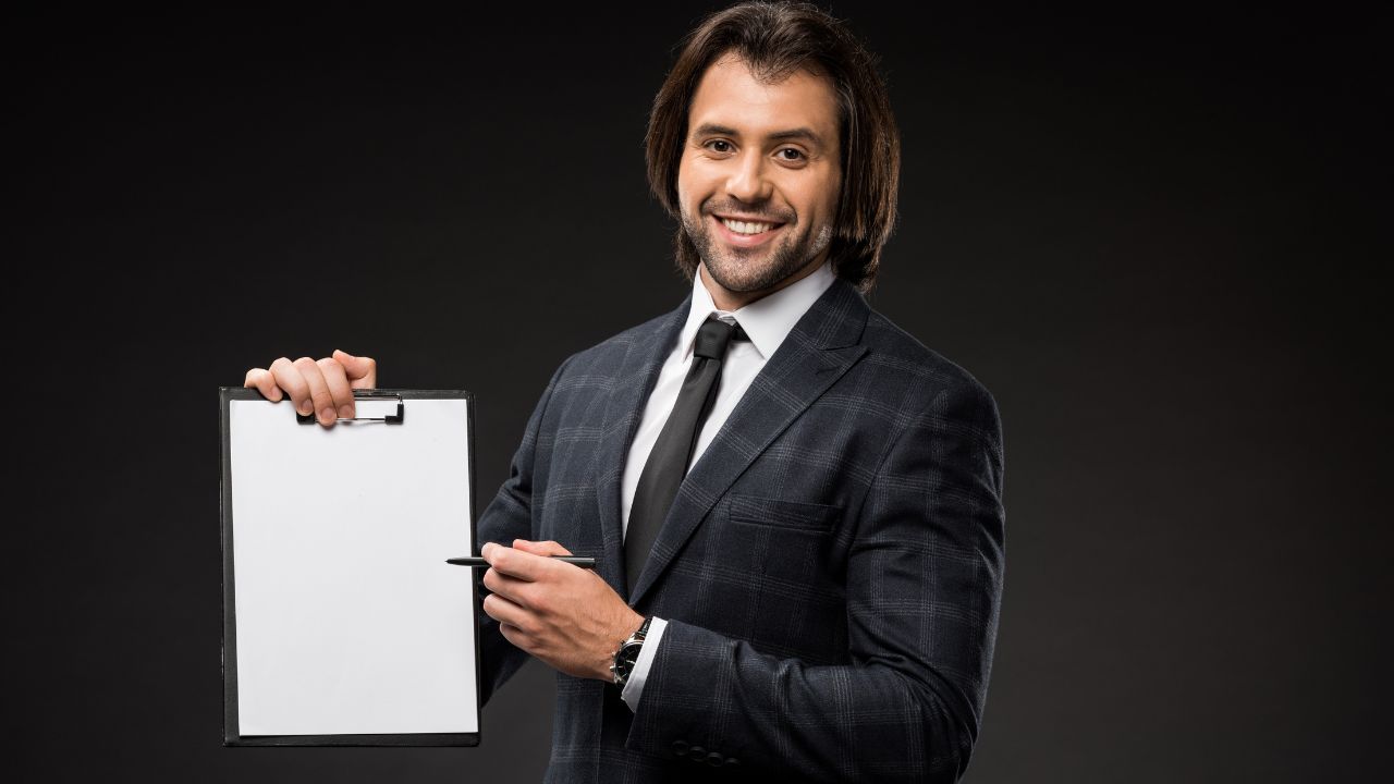 man showing the clipboard he's holding