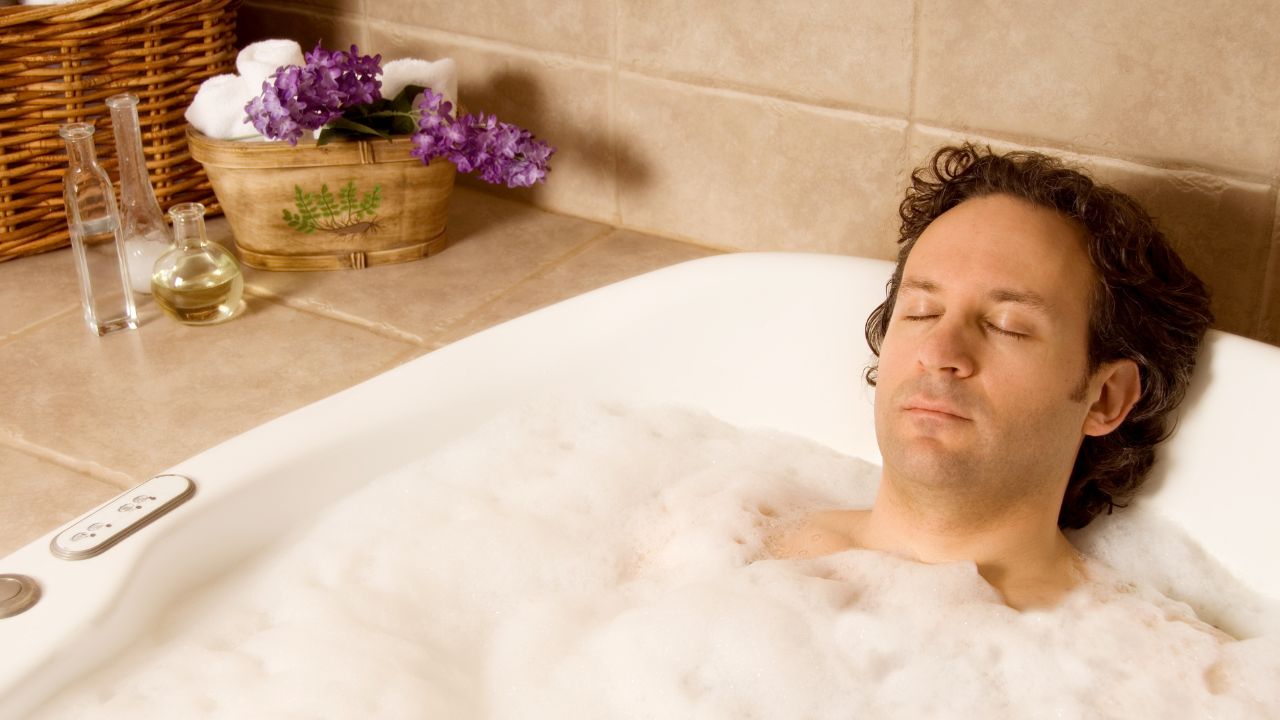 man in a bathtub full of bubbles