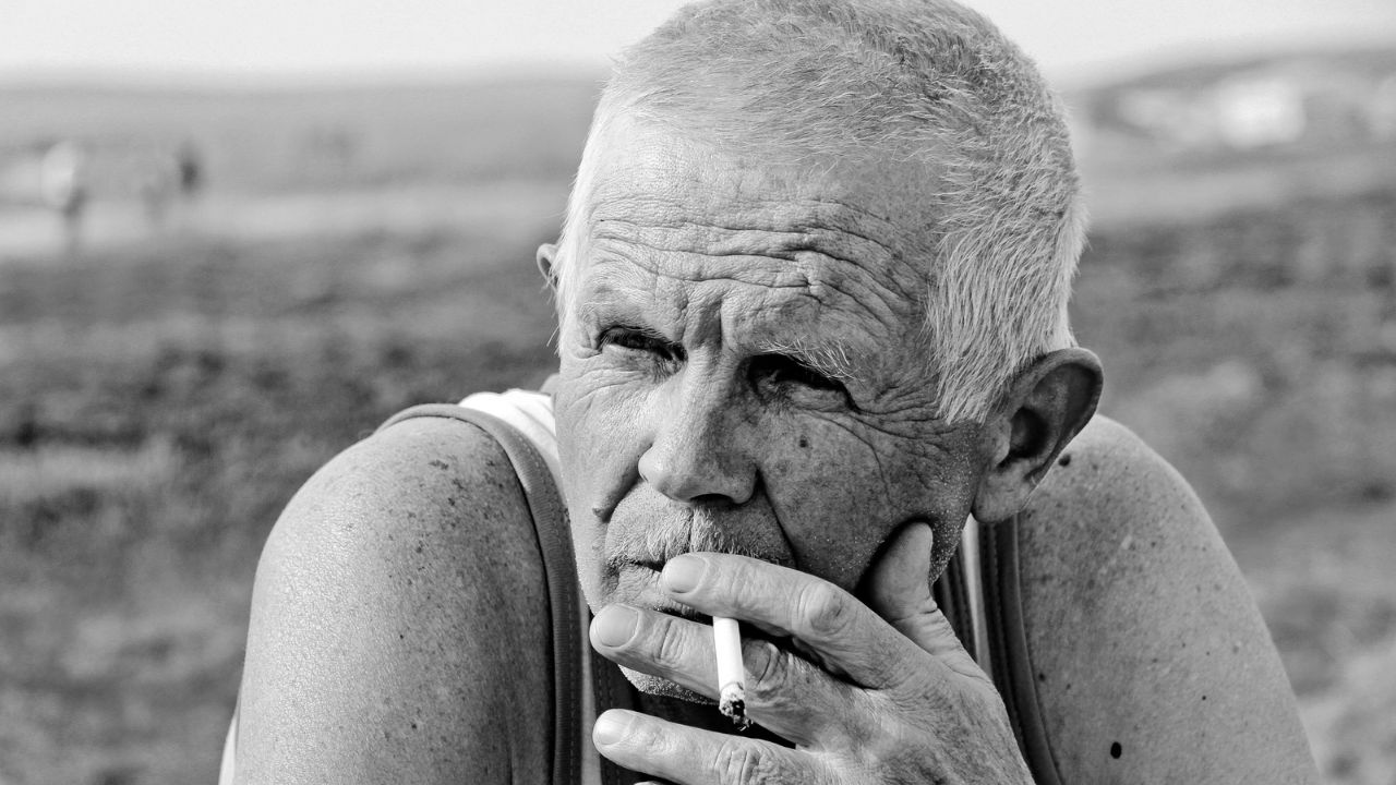 older man from silent generation smoking a cigarette