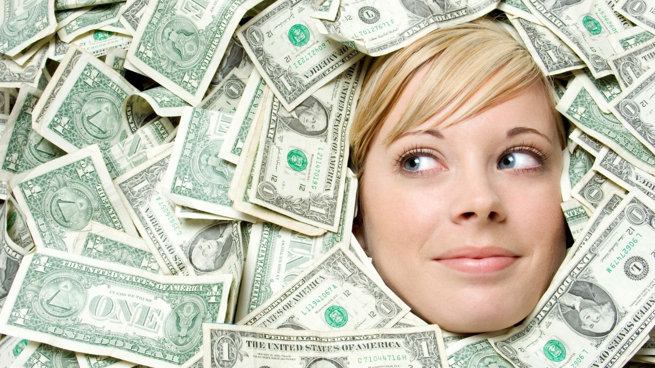 woman with face surrounded by money