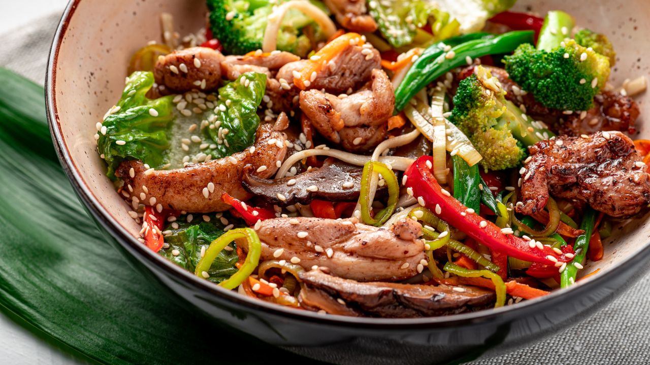 meat strips and vegetable stir fry in a bowl