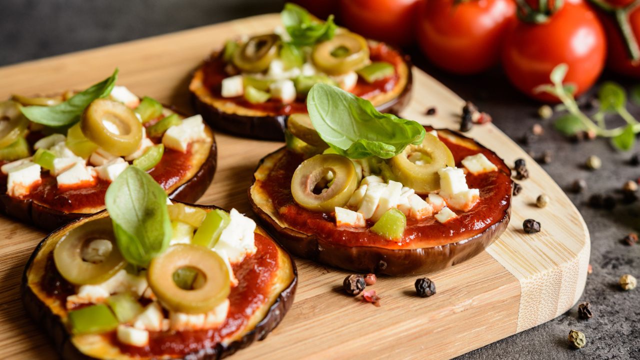eggplant pizzas with tomato sauce, cheese and olives