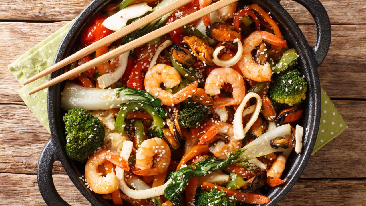 shrimp stir fry in a wok with chopsticks